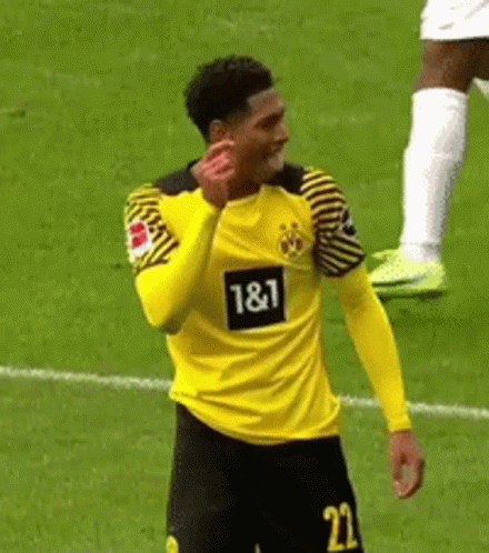 A Soccer Player Wearing A Yellow And Black Jersey With The Number 22 On It Is Standing On A Field . GIF