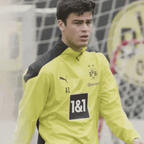 A Soccer Player Wearing A Yellow And Black Jersey With The Number 32 On It GIF