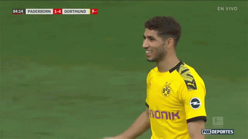a soccer player wearing a yellow bvb jersey