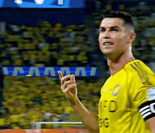 A Soccer Player Wearing A Yellow Jersey Is Giving A Thumbs Up GIF