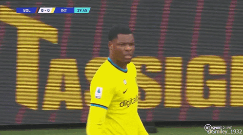 A Soccer Player Wearing A Yellow Jersey Is Walking On A Field . GIF