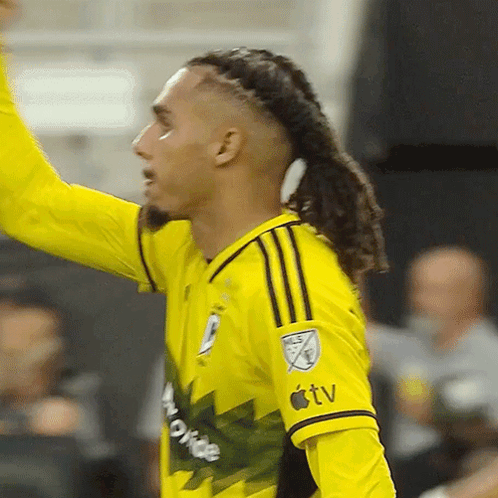 A Soccer Player Wearing A Yellow Jersey That Says Apple Tv On The Sleeve GIF