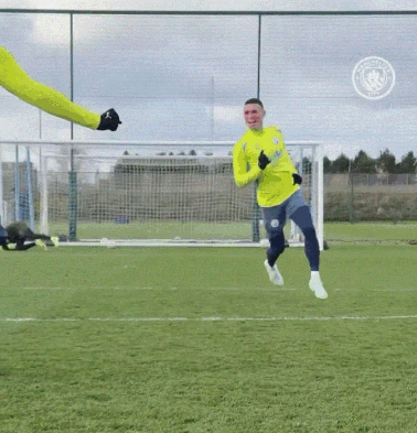 a soccer player wearing a yellow jersey that says manchester city on it