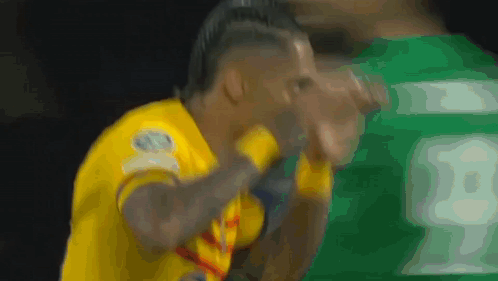 A Soccer Player Wearing A Yellow Jersey With The Number 18 On It GIF