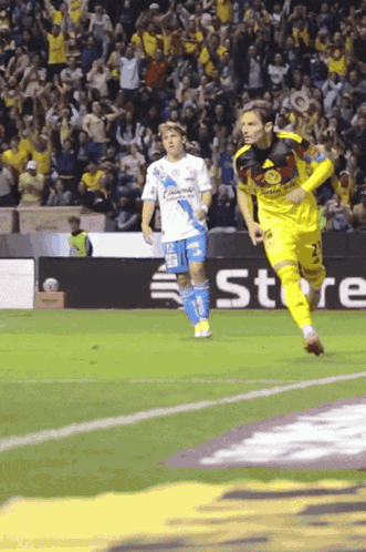 A Soccer Player Wearing A Yellow Jersey With The Number 2 On It Is Running On The Field GIF