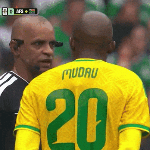 a soccer player wearing a yellow jersey with the number 20 on it