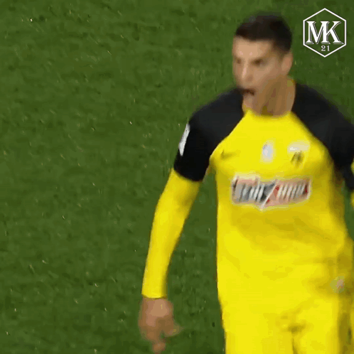 A Soccer Player Wearing A Yellow Jersey With The Word Mk On The Bottom GIF