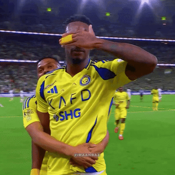 A Soccer Player Wearing A Yellow Kafd Shg Jersey Covers His Eyes GIF
