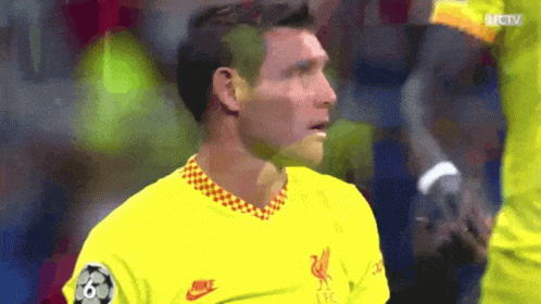 A Soccer Player Wearing A Yellow Nike Shirt Looks At The Camera GIF