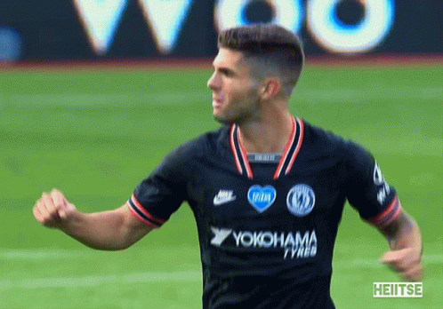 a soccer player wearing a yokohama jersey celebrates on the field