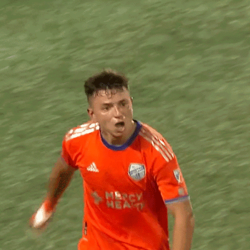A Soccer Player Wearing An Orange Jersey That Says Nbc Health On It GIF