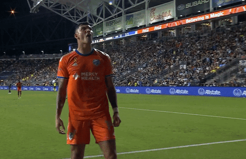 A Soccer Player Wearing An Orange Mercy Health Jersey GIF