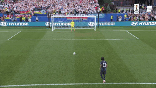 A Soccer Player Wearing Number 13 Kicks The Ball Into The Goal GIF