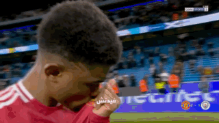 A Soccer Player Wipes His Eyes With His Hand In Front Of A Banner That Says ' Tiger ' On It GIF