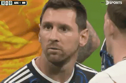 a soccer player with a beard is talking to another player on a field .