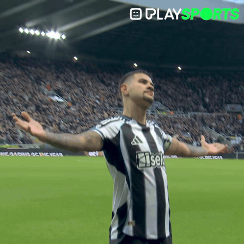 A Soccer Player With His Arms Outstretched Is Wearing A Black And White Striped Shirt That Says Iseki GIF