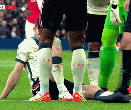 A Soccer Player With Lfc On His Socks GIF