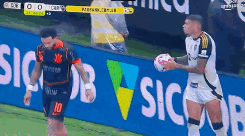 a soccer player with the number 10 on his jersey holds a ball