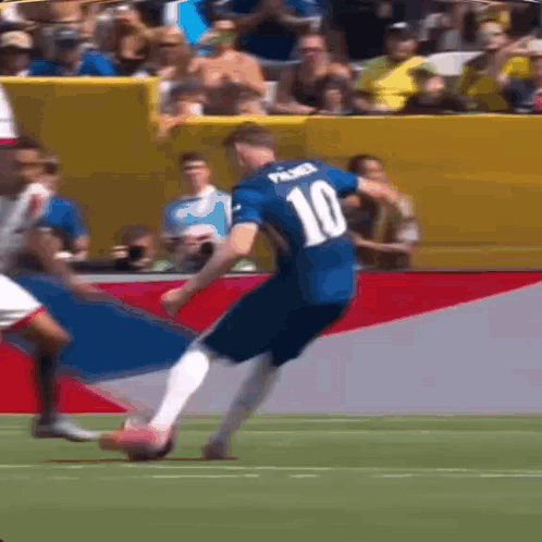 A Soccer Player With The Number 10 On His Jersey Is Kicking A Soccer Ball . GIF
