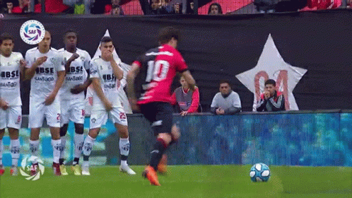 A Soccer Player With The Number 10 On His Jersey Is Kicking The Ball GIF