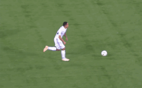 a soccer player with the number 10 on his jersey kicks the ball