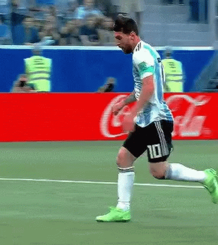 A Soccer Player With The Number 10 On His Shorts Is Running On The Field . GIF