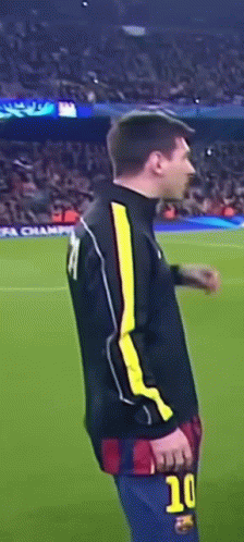 A Soccer Player With The Number 10 On His Shorts Is Standing On The Field GIF