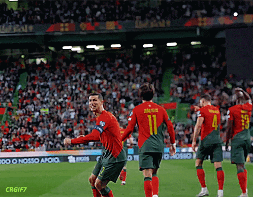 A Soccer Player With The Number 11 On His Back Is Celebrating With His Teammates GIF