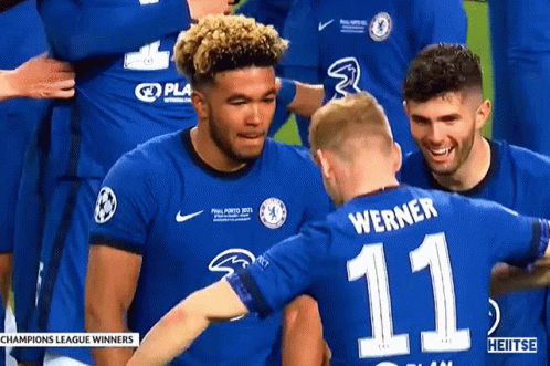 A Soccer Player With The Number 11 On His Back Is Hugging Another Player GIF