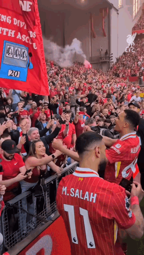 A Soccer Player With The Number 11 On His Back Is Surrounded By Fans GIF