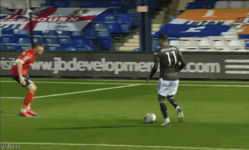 A Soccer Player With The Number 11 On His Jersey Is Kicking The Ball GIF
