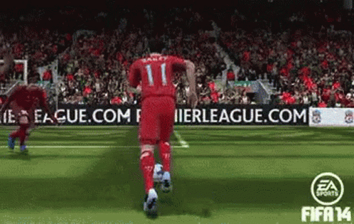 A Soccer Player With The Number 11 On His Jersey Is Running With A Soccer Ball GIF