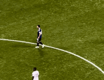 a soccer player with the number 11 on his jersey is surrounded by other players
