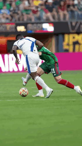 A Soccer Player With The Number 11 On His Shorts Is Trying To Steal The Ball From Another Player GIF