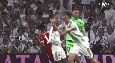 A Soccer Player With The Number 12 On His Shorts Is Being Tackled By Another Player GIF