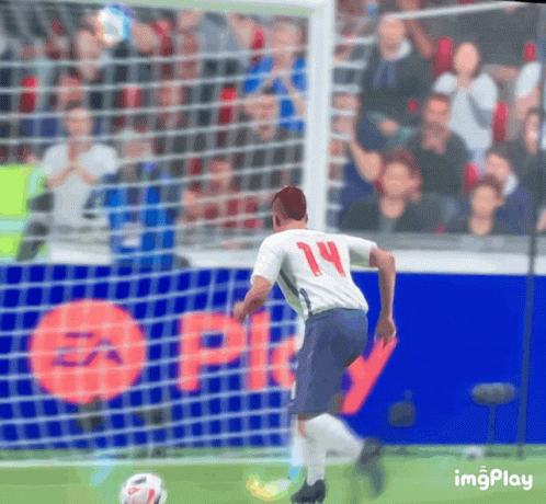 a soccer player with the number 14 on his jersey is kicking the ball