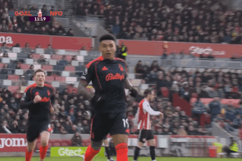 a soccer player with the number 15 on his jersey is running