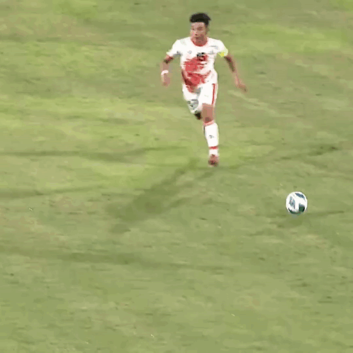 a soccer player with the number 16 on his jersey kicks the ball