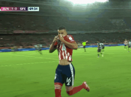 a soccer player with the number 16 on his shorts is running on the field
