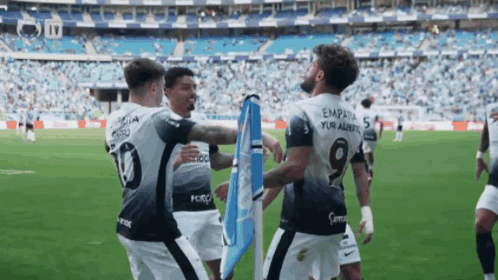 a soccer player with the number 19 on his back is hugging another player