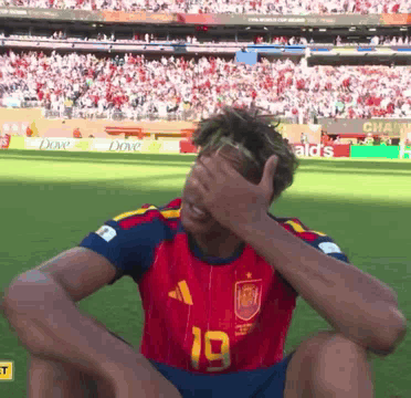 A Soccer Player With The Number 19 On His Jersey Covering His Face GIF