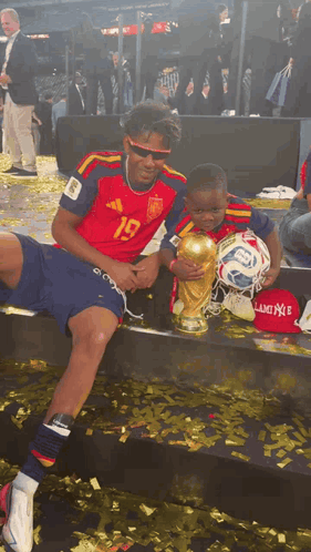 A Soccer Player With The Number 19 On His Jersey Holds A Trophy GIF
