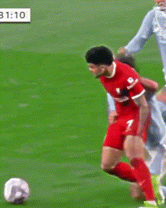 A Soccer Player With The Number 2 On His Shorts Is Trying To Tackle Another Player GIF