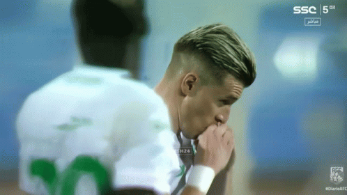 A Soccer Player With The Number 20 On His Shirt Looks Down GIF
