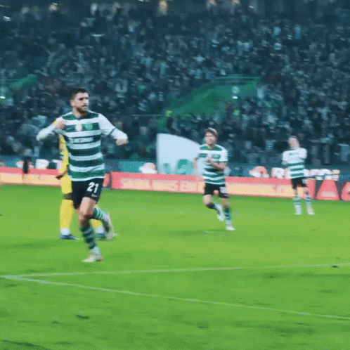 A Soccer Player With The Number 21 On His Jersey Is Running On The Field GIF