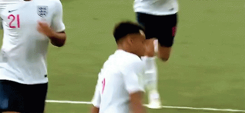 A Soccer Player With The Number 21 On His Shirt Is Standing On A Field . GIF