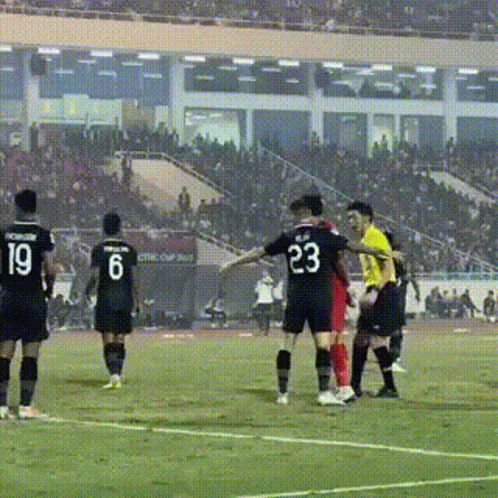A Soccer Player With The Number 23 On His Back Is Being Tackled By Another Player GIF