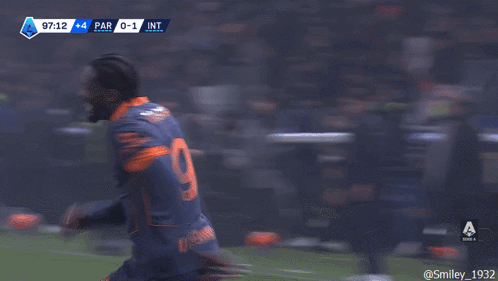 a soccer player with the number 23 on his back is hugging another soccer player