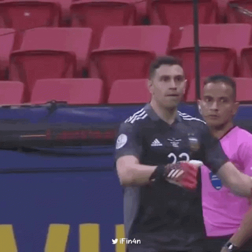 A Soccer Player With The Number 23 On His Jersey Is Standing In A Stadium . GIF