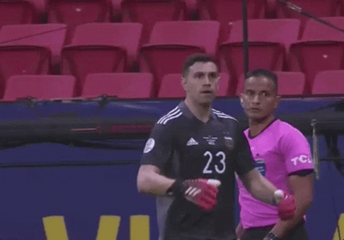 A Soccer Player With The Number 23 On His Jersey Is Standing In Front Of A Microphone . GIF